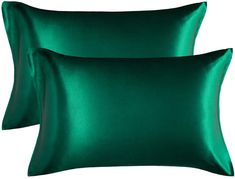 two green satin pillows on a white background