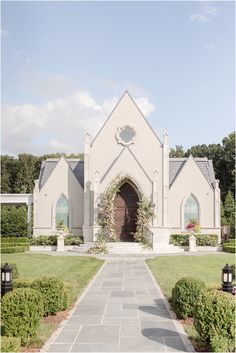 a large white church with a walkway leading to the front door and side entrance area