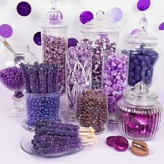 there are many different types of candies in glass jars