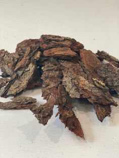 a pile of wood sitting on top of a white table