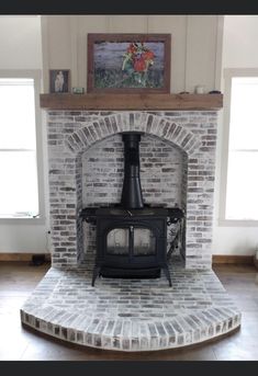 a brick fireplace with a wood burning stove