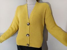 "This is a yellow sweater for women. It's fisherman rib knitted. This cardigan is lightweight and keeps you warm. It has a v-neck collar and 3 buttons. It's a cozy casual knitwear jacket. The lenght of the small size sweater from collar to bottom: 56cm (22\"). If you need larger ones please let us know." Yellow Ribbed Sweater For Winter, Yellow Knitted Cardigan For Spring, Spring Yellow Knitted Cardigan, Yellow Buttoned Sweater For Spring, Yellow Button Sweater For Spring, Yellow Buttoned Cardigan, Yellow Casual Cardigan With Buttons, Yellow Buttoned Sweater For Fall, Casual Yellow Cardigan With Buttons