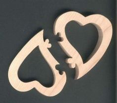 two pieces of wood cut out to look like hearts