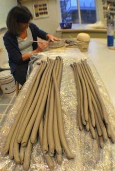 a woman is working on some kind of sculpture