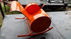 an orange chair sitting on top of a cement slab