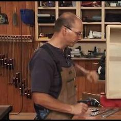 a man in an apron working on a computer