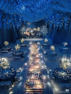 an overhead view of a ballroom with tables and chairs covered in blue lights, surrounded by snow