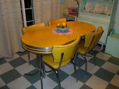 a dining room table with yellow chairs around it