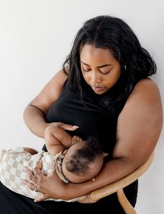 a woman holding a baby in her arms