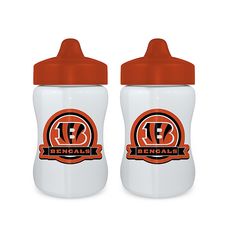 two orange and white baby bottles sitting next to each other