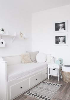 a bedroom with white furniture and pictures on the wall, including a daybed bed