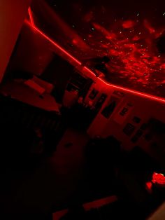 the room is dimly lit with red lights