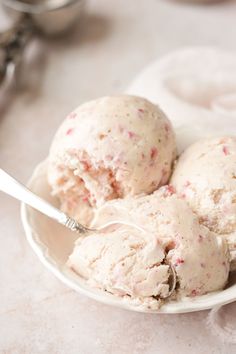 two scoops of ice cream in a white bowl