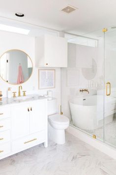 an instagram page with a white bathroom and gold accents