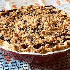 a pie sitting on top of a table covered in crumbly toppings,