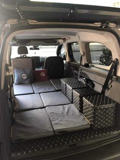 the back end of a van with luggage in it