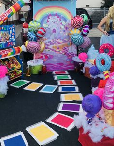 an assortment of candy and candies on display in front of a carnival booth at a fair