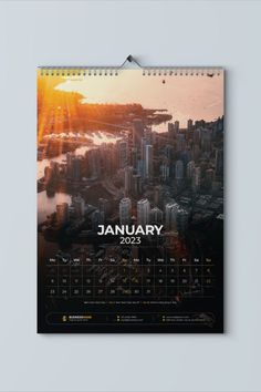 a calendar with the sun setting over a city