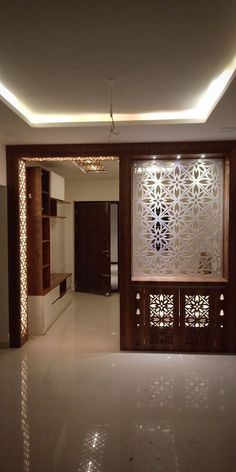 an empty living room with white tile flooring and wooden partitions on the wall