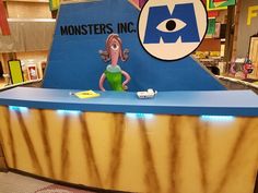 a counter in a store with an eye on the sign above it that says monsters inc