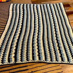 two crocheted rugs sitting on top of a wooden floor