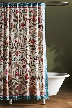 the shower curtain is decorated with colorful flowers and leaves