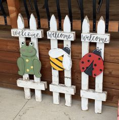 three wooden signs that say welcome, welcome and welcome with ladybugs on them