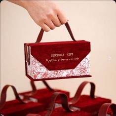 a person is holding a red and white box with the words sunday gift on it