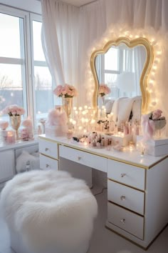 a white vanity with lights on it and a mirror in front of the window that is decorated with pink flowers