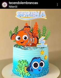 a birthday cake decorated with an image of nemo and dory fish on top