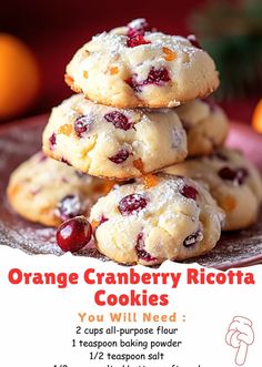 orange cranberry ricotta cookies are stacked on top of each other in front of an orange background