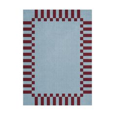 a blue rug with red and white squares on the bottom, in front of a white background