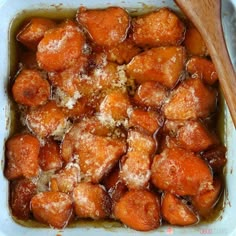 a casserole dish filled with cooked carrots and parmesan cheese