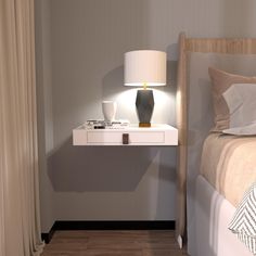 a nightstand with a lamp on it next to a bed