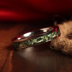 two wedding bands sitting on top of a wooden table next to some burlies