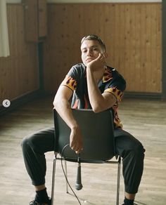 a man sitting on top of a black chair