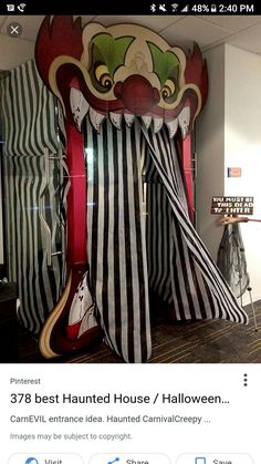 an image of a creepy clown tent with black and white stripes on the front, red stripe around the top