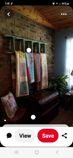 an image of a living room with clothes hanging on the rack and other items displayed