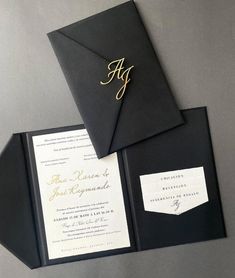 a black and white wedding suite with gold lettering on the front, inside and outside