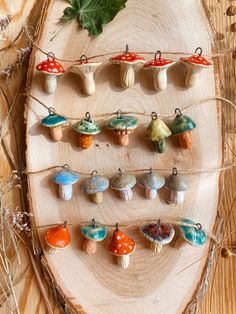 small ceramic mushrooms are hanging on a string