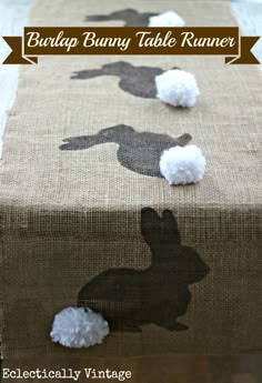 the table runner is decorated with silhouettes of rabbits and pom - poms