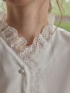 Color
White


Detail
Lace collar and placket; Two layers of openwork lace; Pearl buttons



Composition

100% Polyester



Washing Method

Hand wash in cool water, using a mild and gentle detergent. Lace Button-up Blouse With Lace Cuffs, Feminine Wedding Blouse With Lace Cuffs, Elegant Blouse With Lace Trim And Ruffled Collar, Formal Blouse With Lace Trim And Ruffled Collar, Elegant Blouse With Lace Cuffs For Daywear, Elegant Lace Work Blouse For Daywear, Elegant Blouse With Lace Trim And Doll Collar, Daywear Lace Top With Lace Cuffs, Feminine Lace Top With Lace Cuffs For Daywear