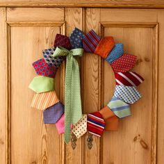 a wreath made out of ties is hanging on the front door's wooden door