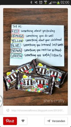 some kind of candy bar that is on top of a wooden table with a note attached to it