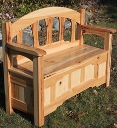 a wooden bench sitting on top of a grass covered field