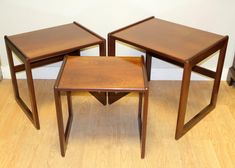 three wooden tables sitting on top of a hard wood floor