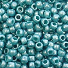 a pile of blue glass beads sitting next to each other