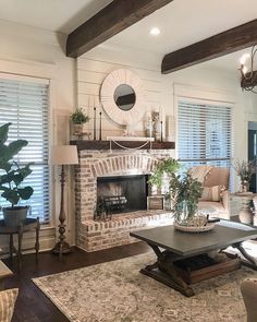 a living room filled with furniture and a fire place in the middle of a room