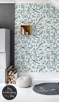 a blue and white wallpaper in a living room with bookshelves on the shelves