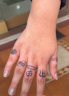 a woman's hand with tattoos on it